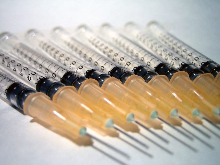 Several syringes and needles for a covid booster shot, COVID booster statistics show efficacy