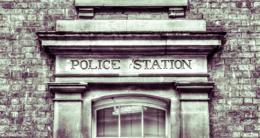 black and white picture of the front of a police station